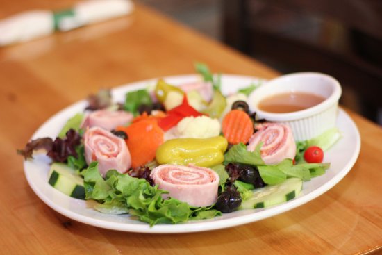 Antipasto salad with rolled ham and salami, olives, pepperoncini and fresh vegetables
